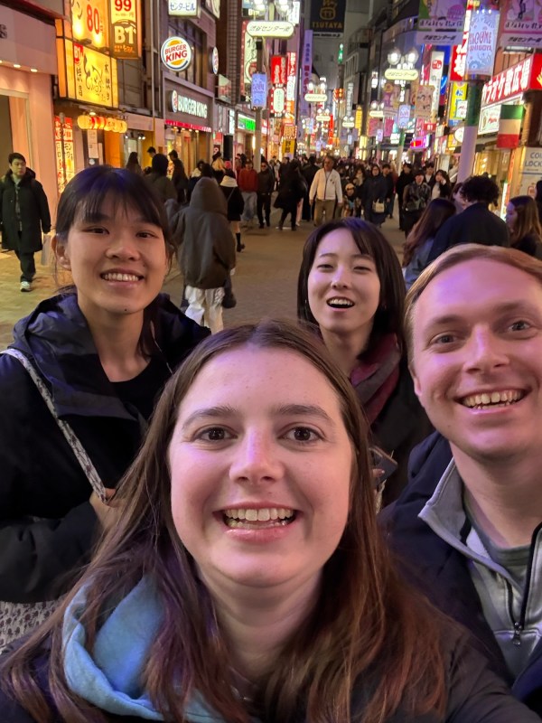 Emily and Bryson with friends on a busy Tokyo street at night