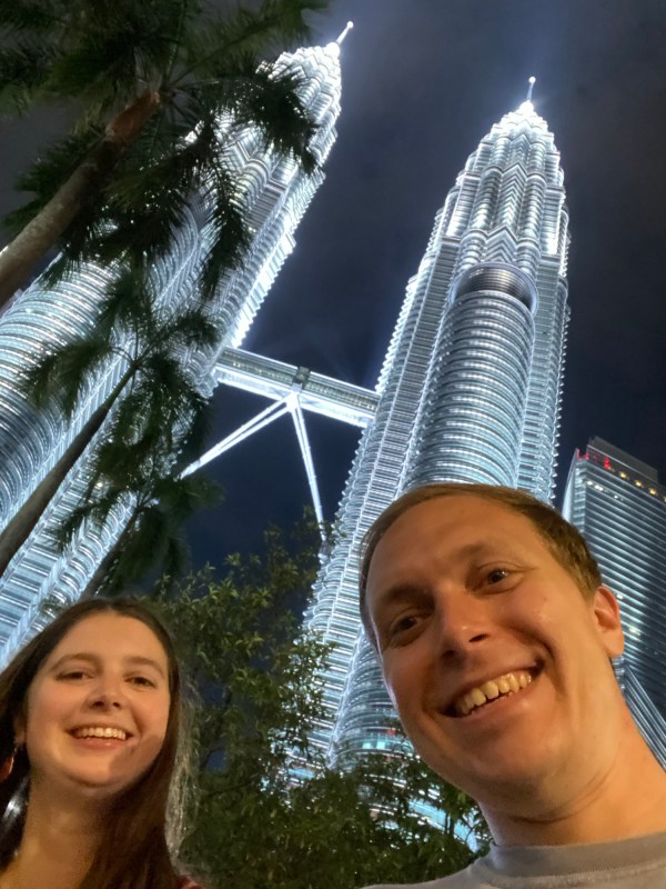 Emily and Bryson beneath the Petronas Twin Towers at night
